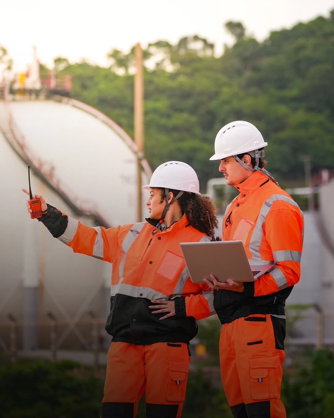 Energy Facilities Inspectors In Orange Clothing.