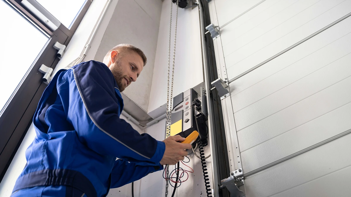 An Electrician Testing A Power Supply Panel.