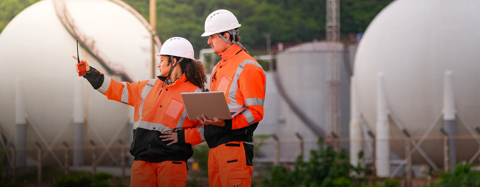 Energy Facilities Inspectors In Orange Clothing.