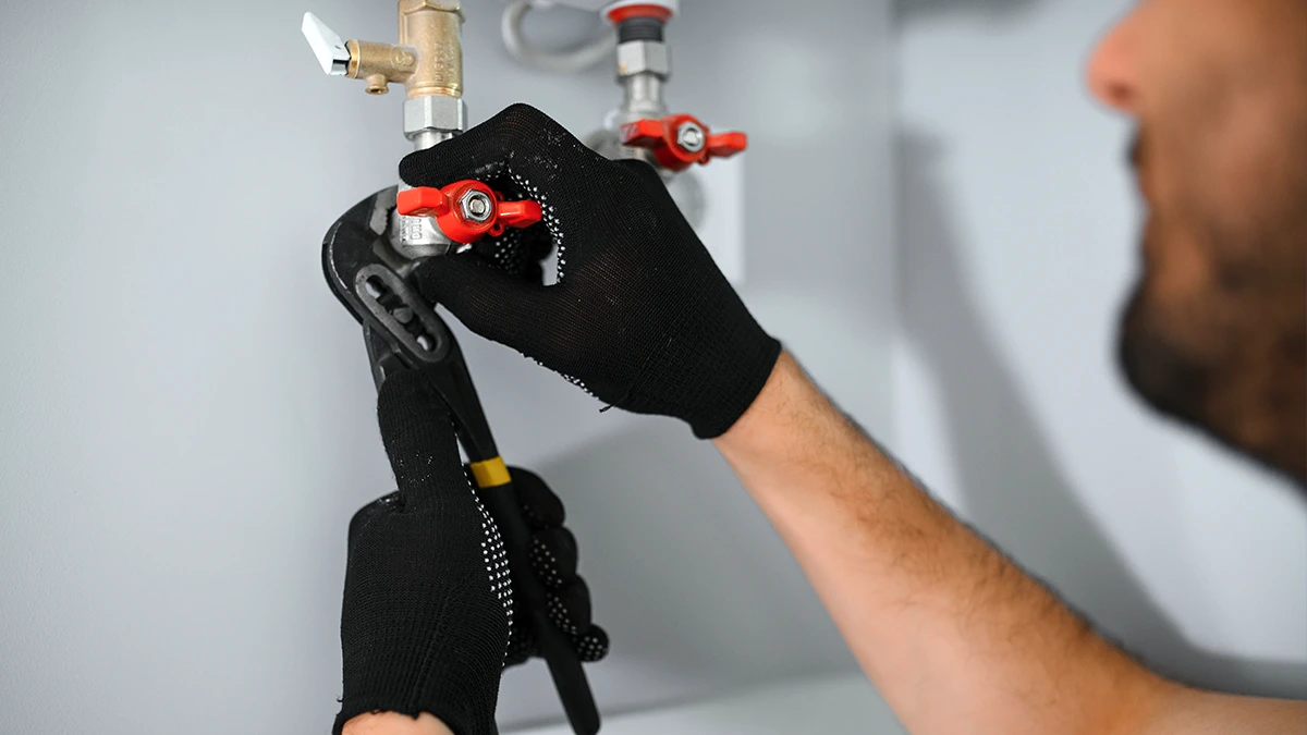 Plumber Fixing A Boiler.